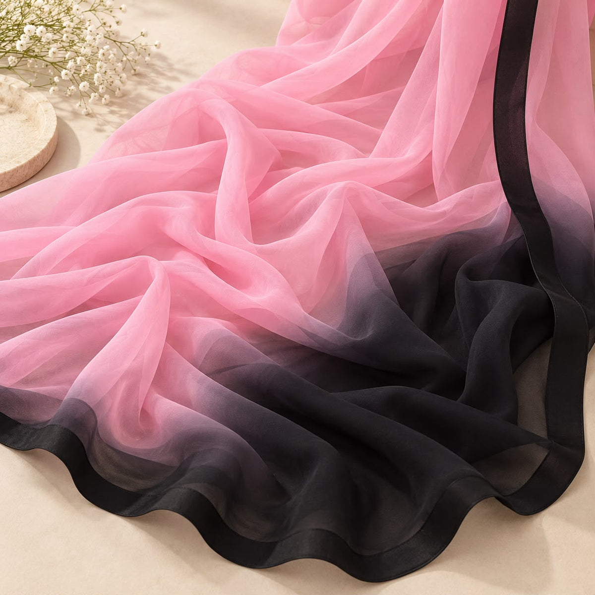 Pink georgette saree with black contrast – fabric and drape detail