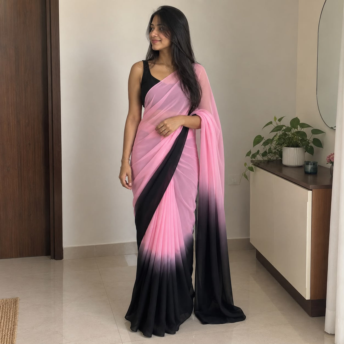 Pink georgette saree with black blouse – full drape view on model