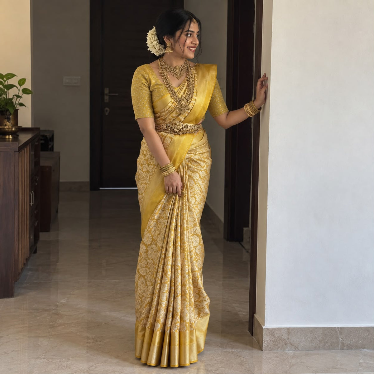Golden yellow Kanjeevaram silk saree with zari woven border – front drape view