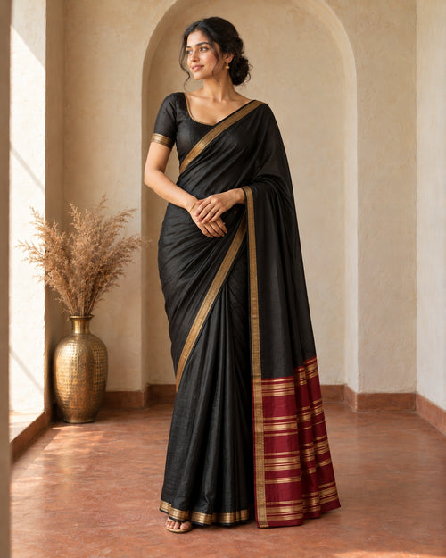 Black Banarasi silk saree with gold zari border and red zari pallu, worn