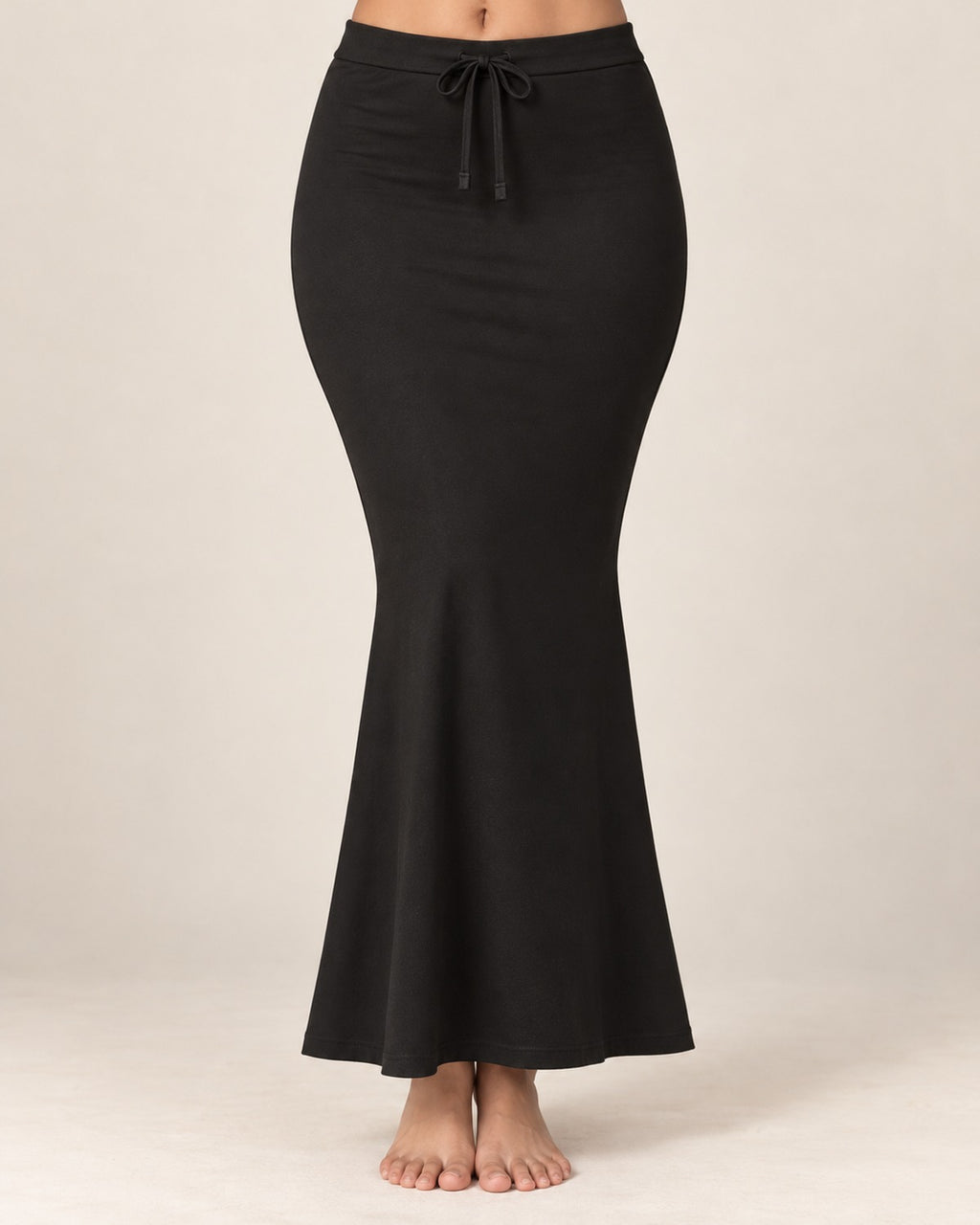 Black fish-cut saree shapewear petticoat worn on a model against a plain ivory background