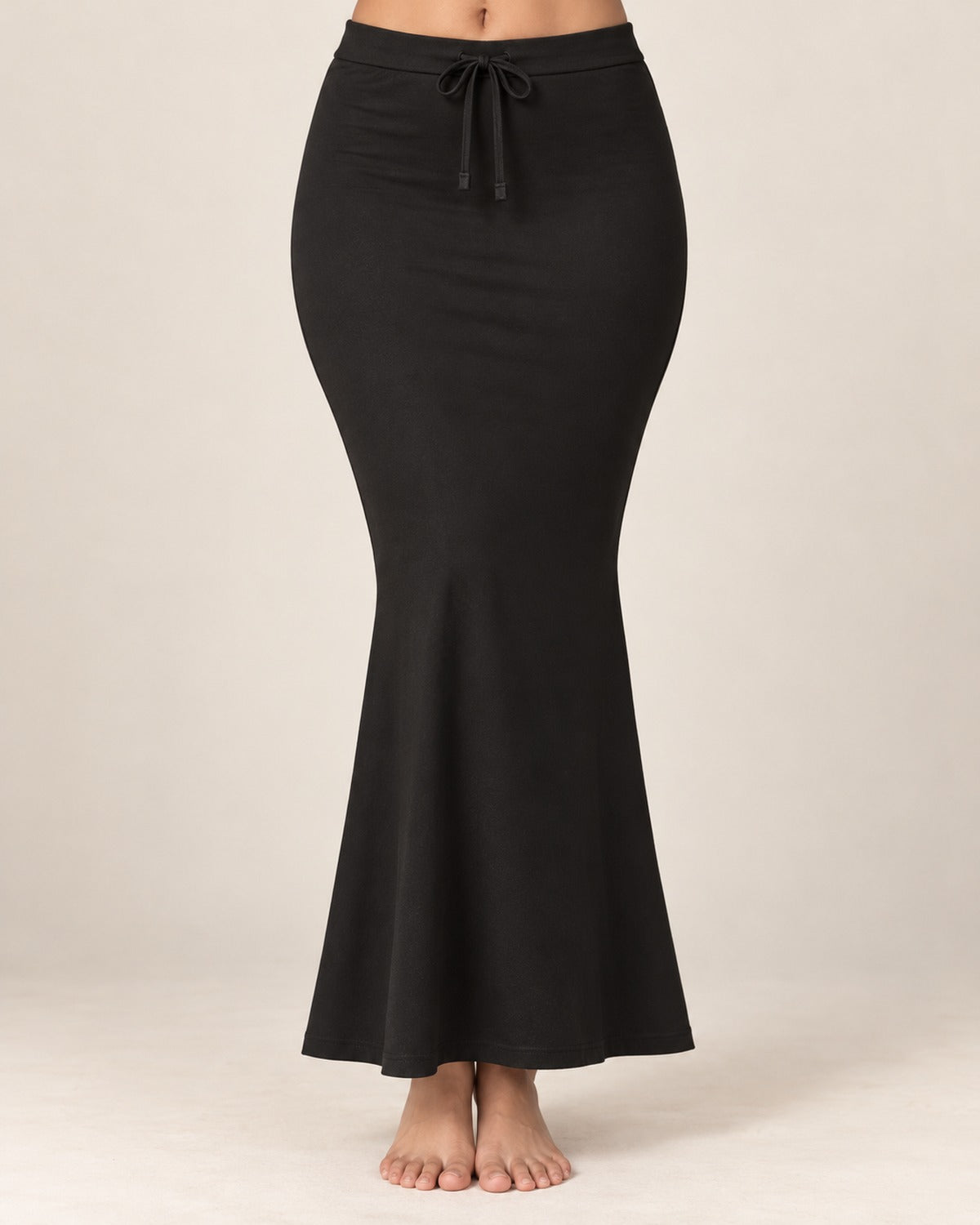 Black fish-cut saree shapewear petticoat worn on a model against a plain ivory background