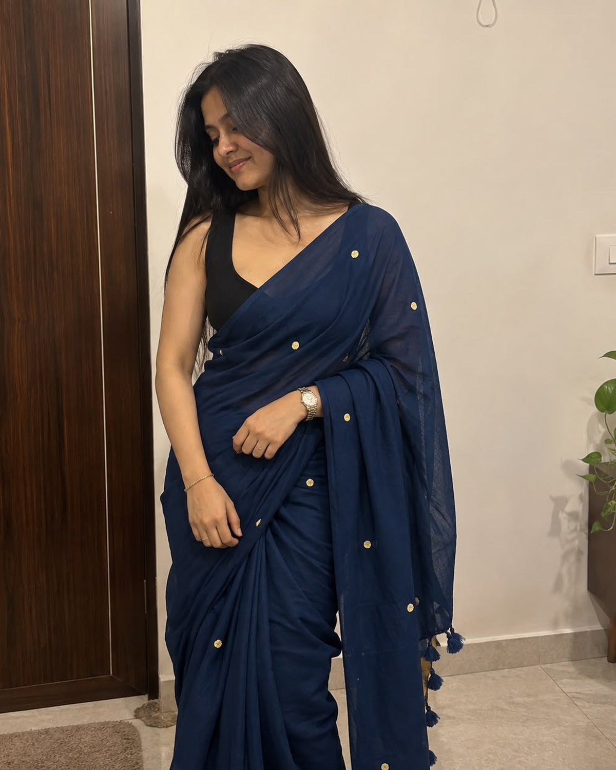 Navy blue crushed cotton blend saree with tassel border, worn