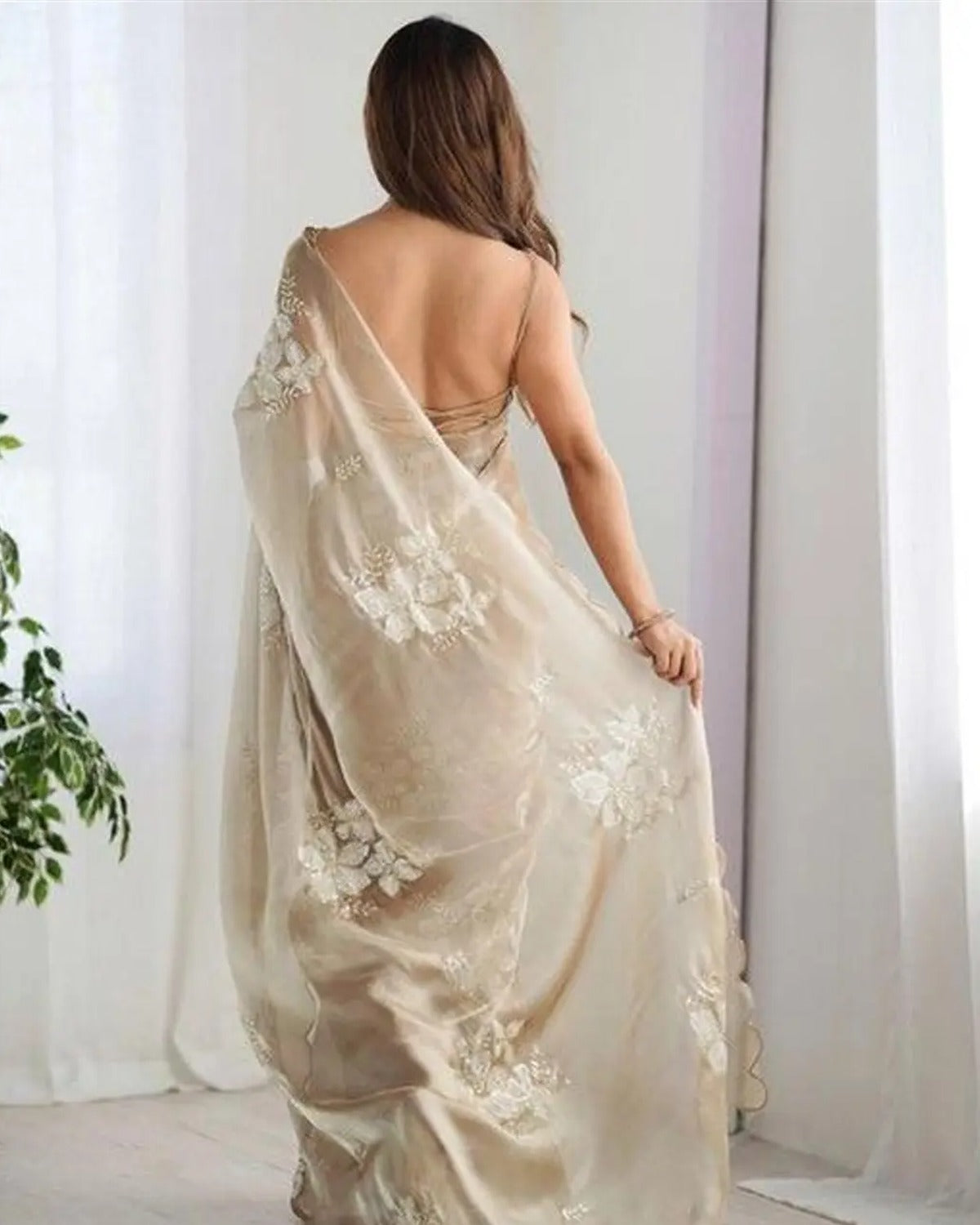 Back view showing the pallu and its floral sequin border