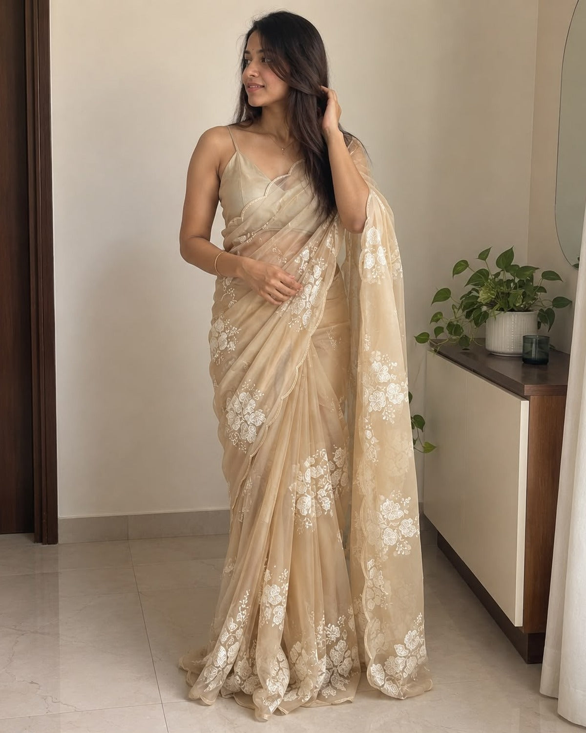 Beige soft silk saree with white floral sequin embellishment, draped