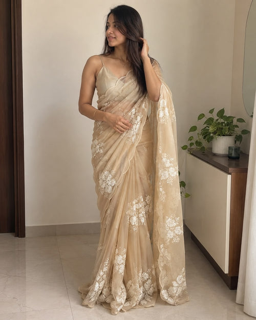 Beige soft silk saree with white floral sequin embellishment, draped