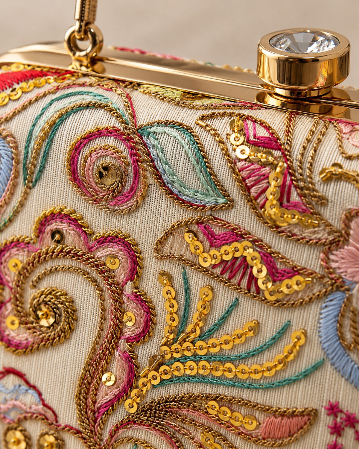 Close detail of the paisley and floral embroidery on the box clutch