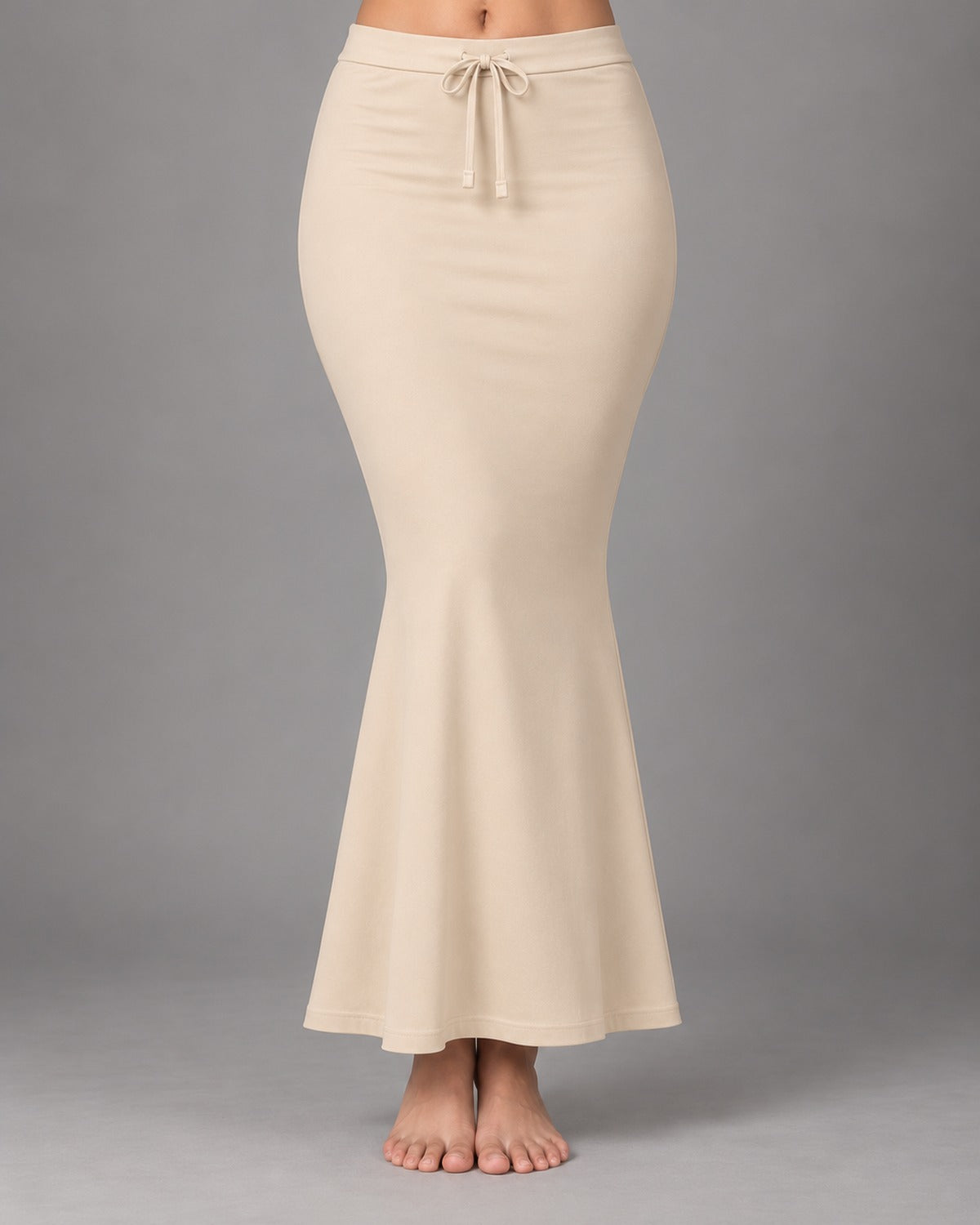Cream fish-cut saree shapewear petticoat worn on a model against a soft grey background