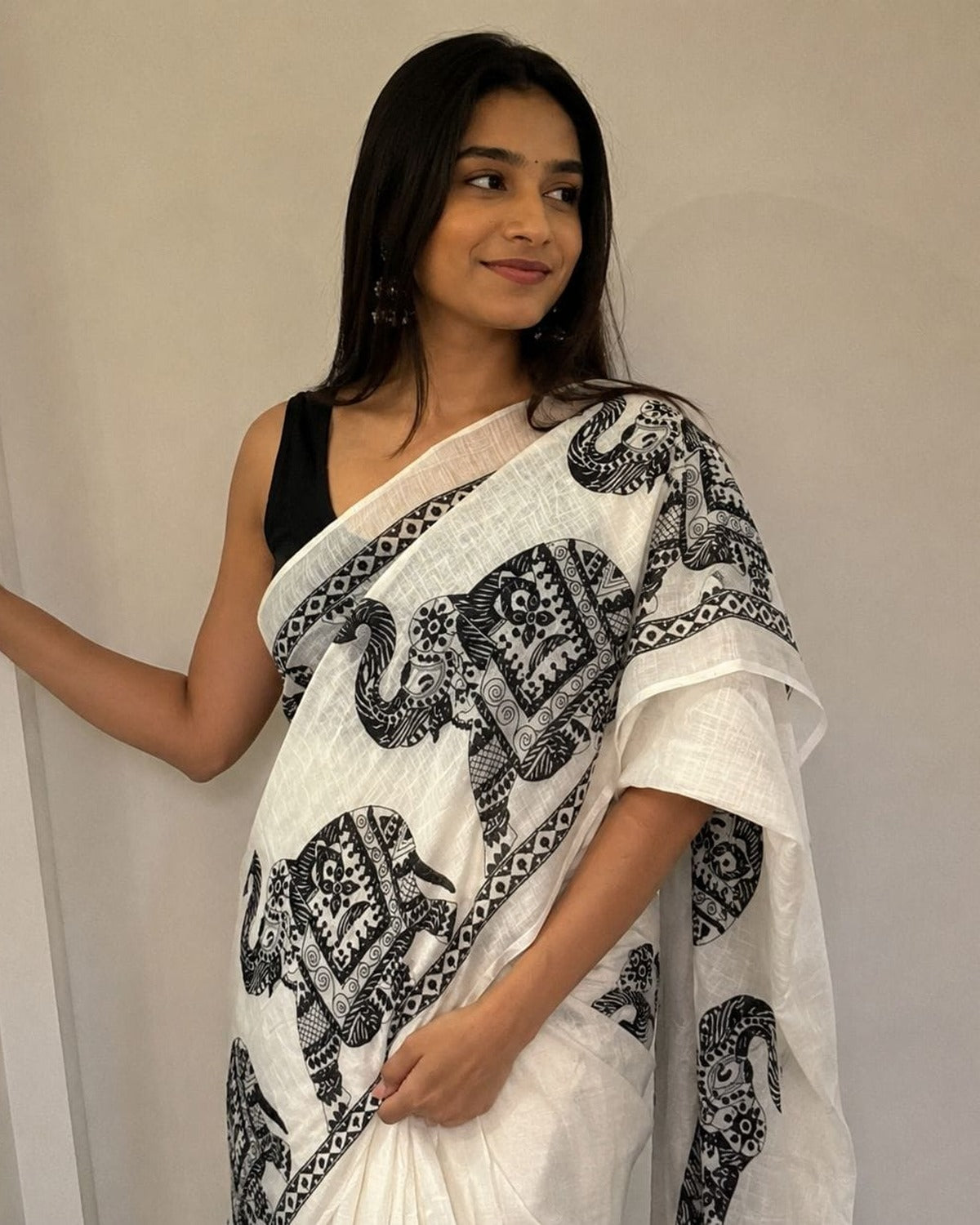 White and black elephant motif saree draped on model