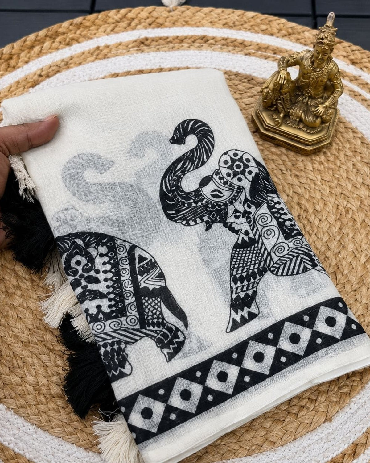 White and black elephant motif saree folded with blouse piece