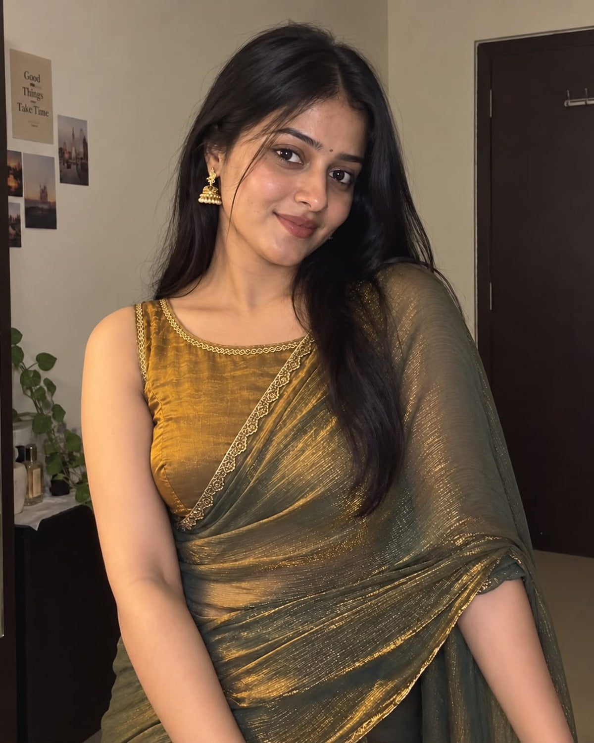 Olive green twill net saree with embellished border, worn