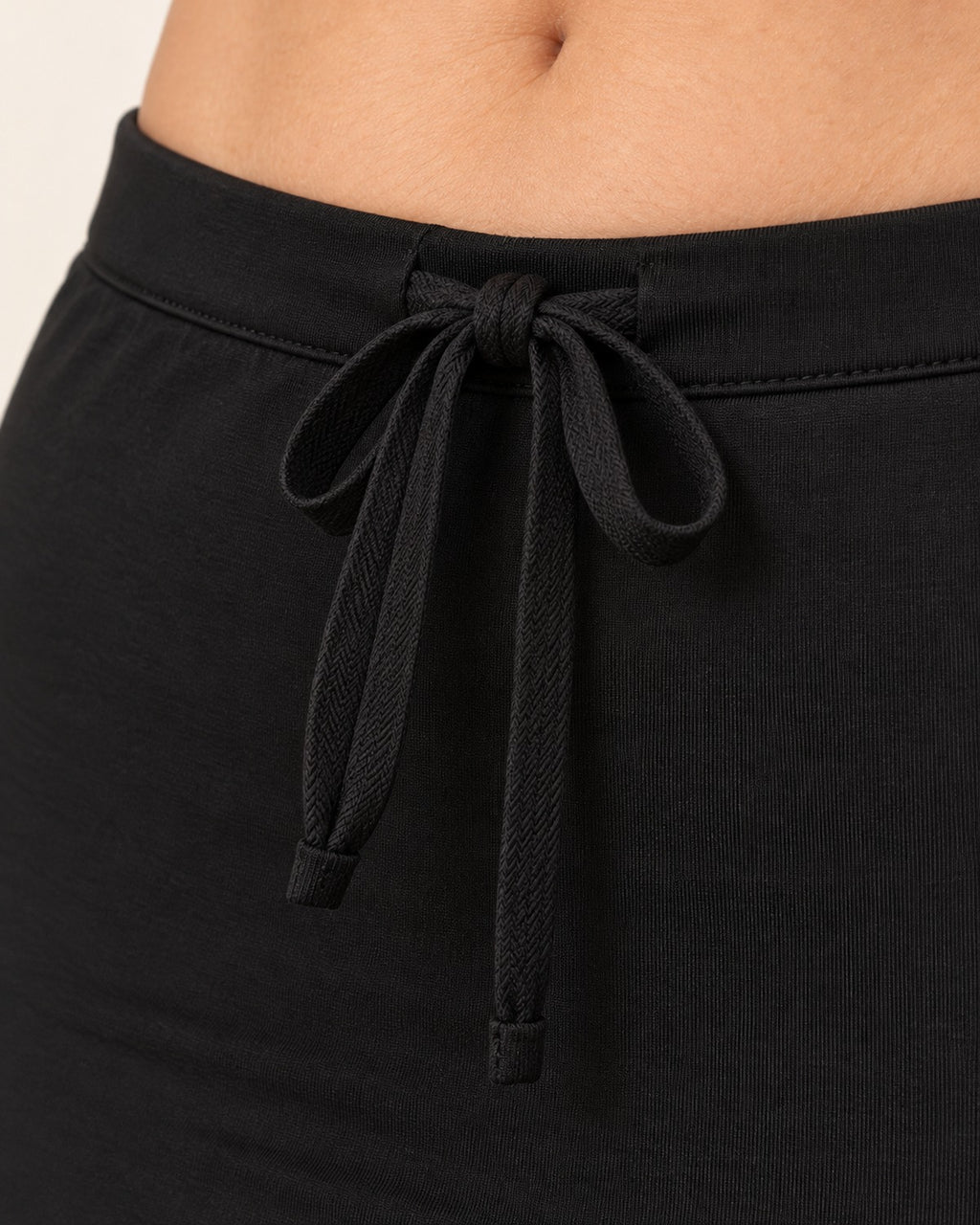 Close detail of the flat elastic waistband and drawstring tie on the shapewear petticoat