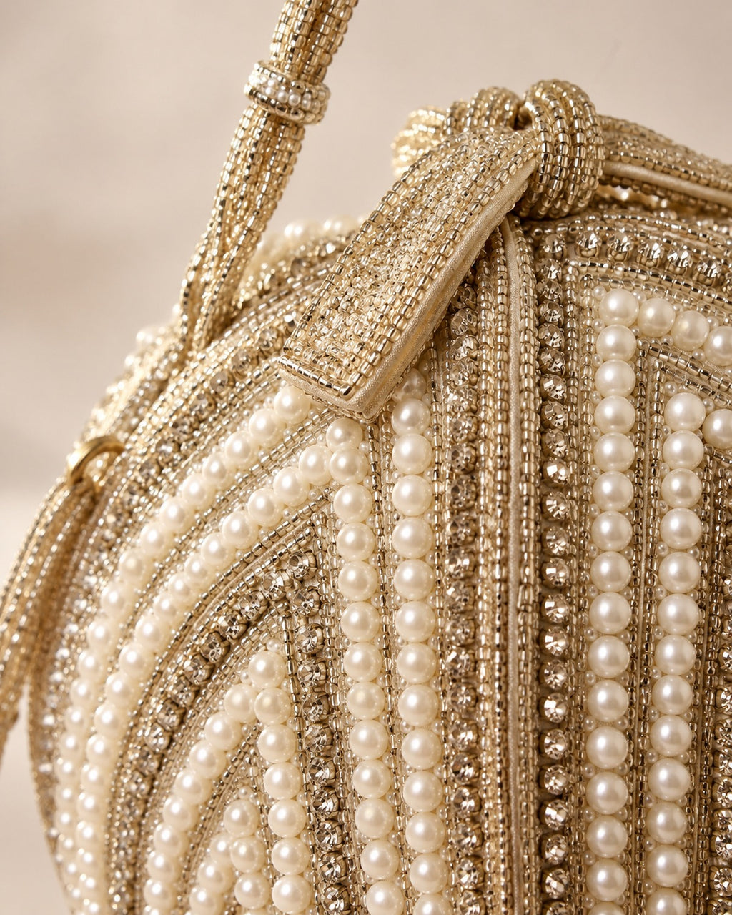 Close detail of the pearl and gold bead work on the potli clutch
