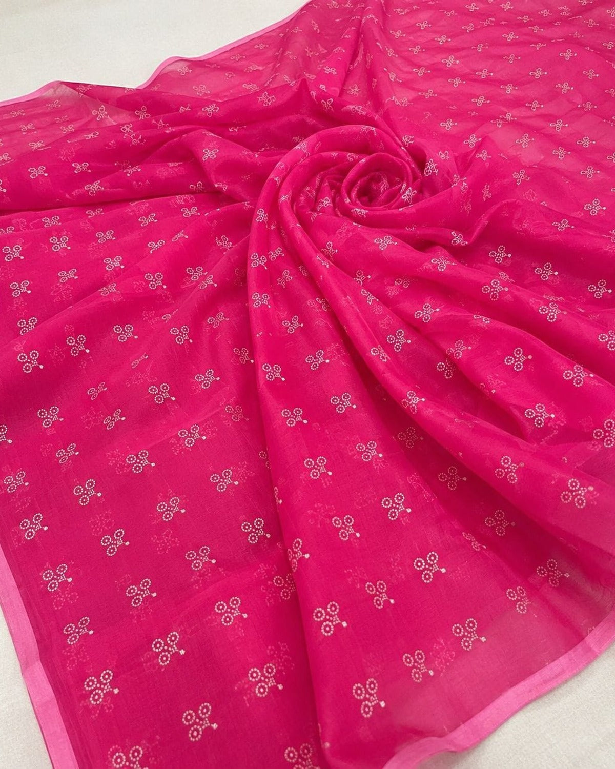 Rani pink floral printed saree folded, showing the print