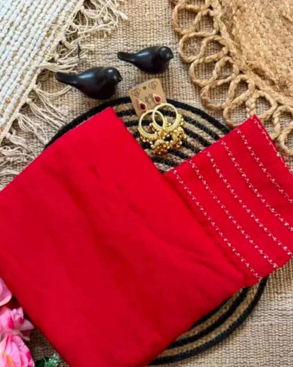 Red crush saree and blouse piece styled flat lay